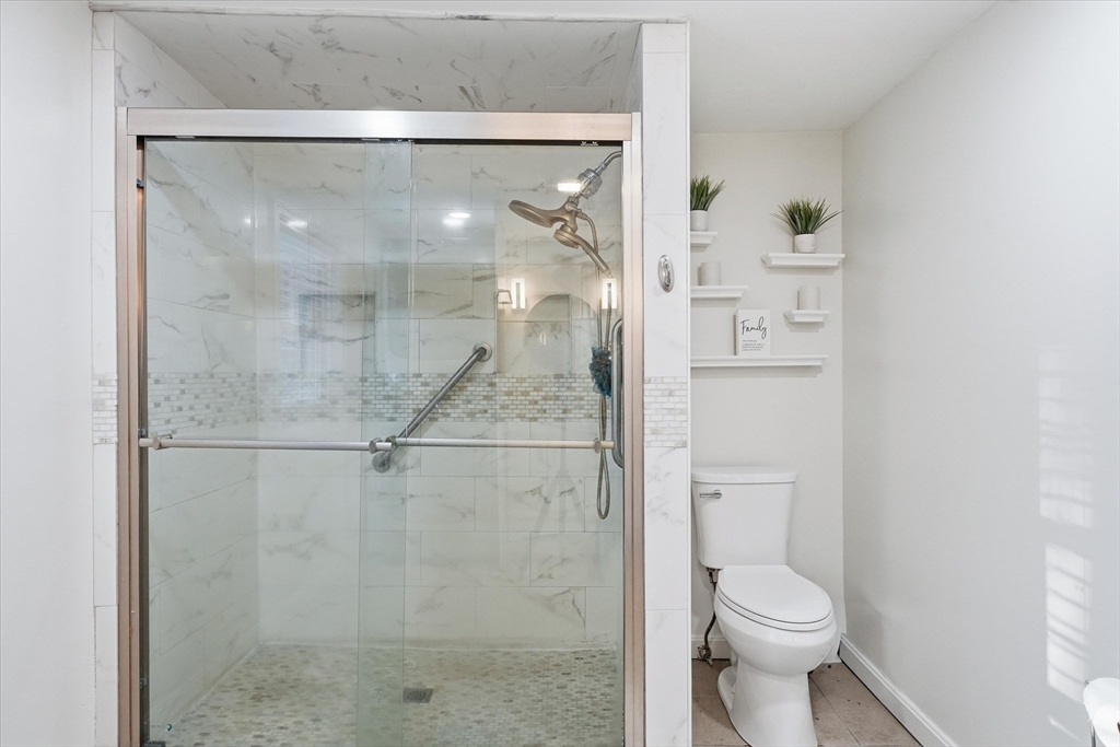 186 Mohawk Trail Haverhill, MA 01832 - Photo 26 of 42 a bathroom with a shower a toilet and a sink