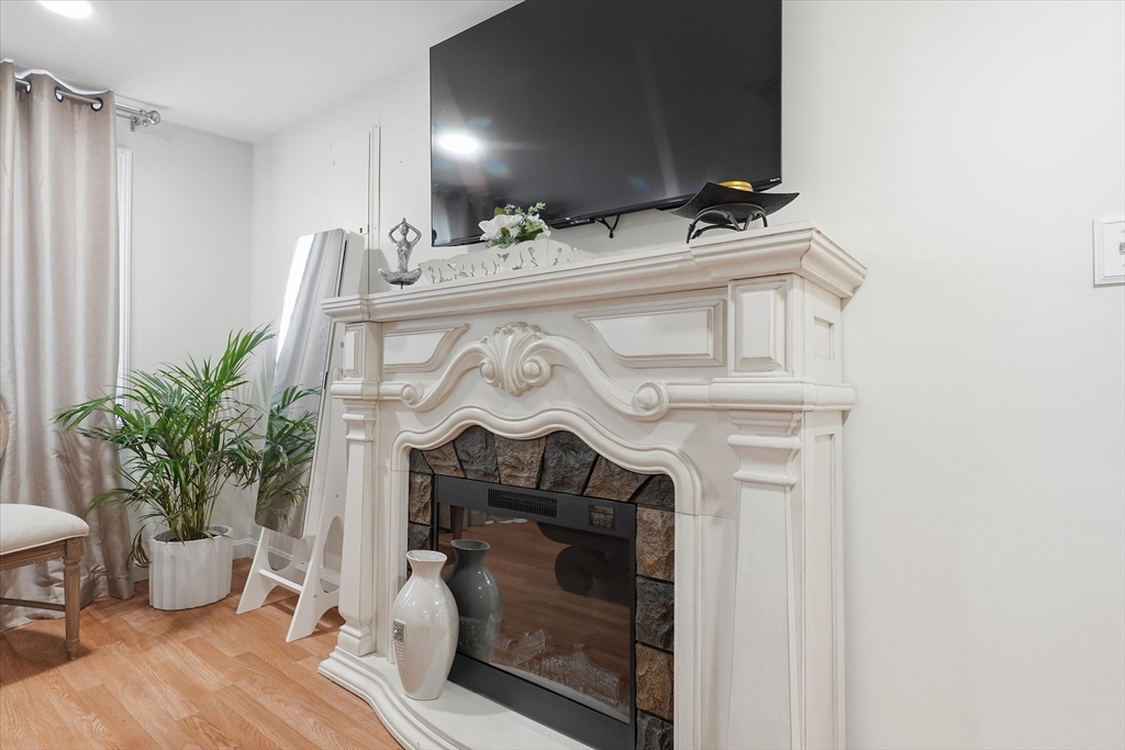 186 Mohawk Trail Haverhill, MA 01832 - Photo 28 of 42 a view of fireplace with wooden floor
