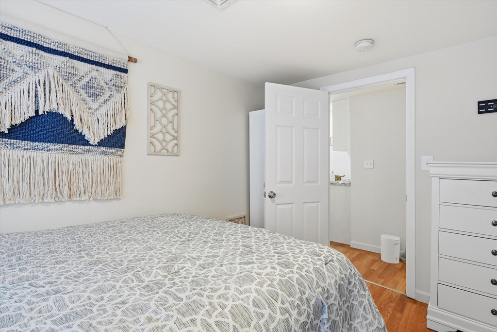 186 Mohawk Trail Haverhill, MA 01832 - Photo 33 of 42 a bedroom with a bed and a walk in closet