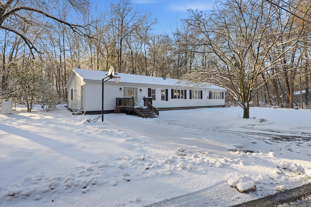 186 Mohawk Trail Haverhill, MA 01832 - Photo 41 of 42 a view of a white house with a yard covered in snow