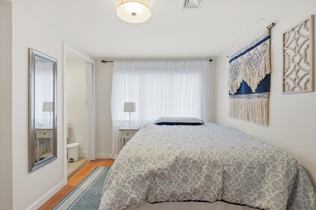 186 Mohawk Trail Haverhill, MA 01832 - Photo 10 of 42 a bedroom with a bed and a painting on the wall