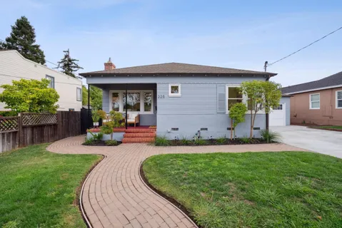 a house view with a sitting space and garden