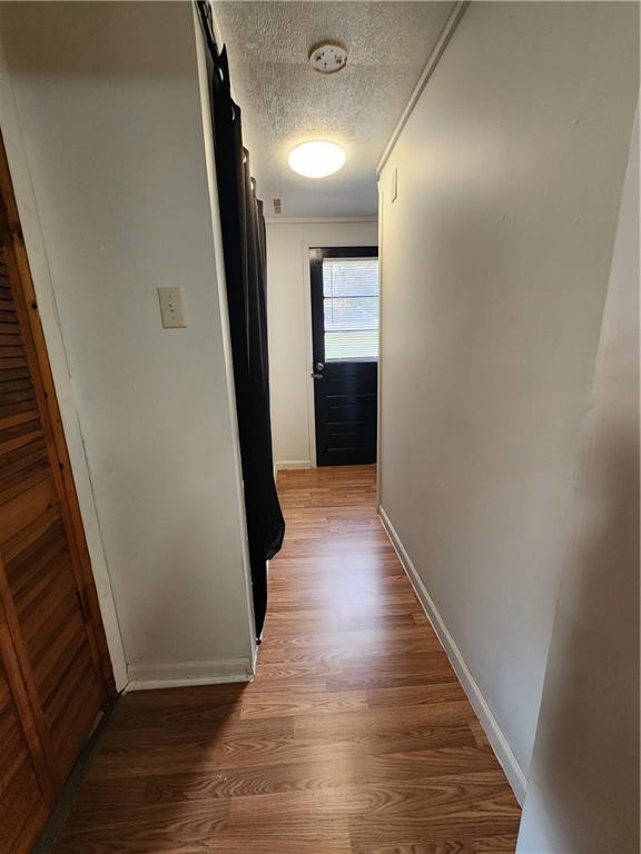 1957 Millerstown Road Tarentum, PA 15084 - Photo 10 of 14 a view of a hallway with wooden floor and staircase