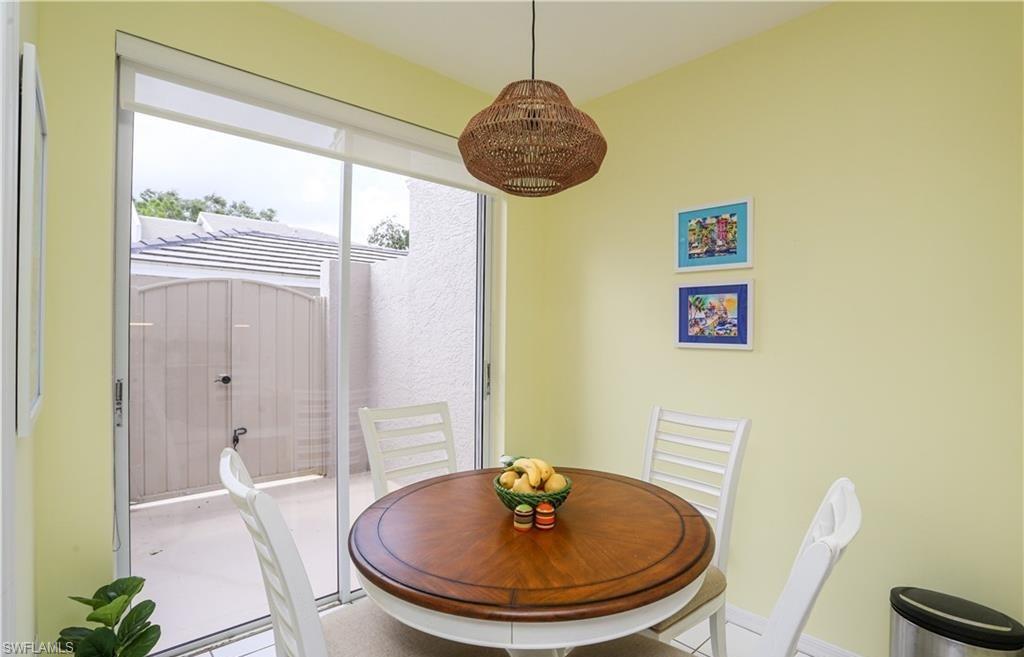 3775 Fieldstone Boulevard, Unit 102 Naples, FL 34109 - Photo 11 of 27 a bathroom with a sink a mirror and a shower