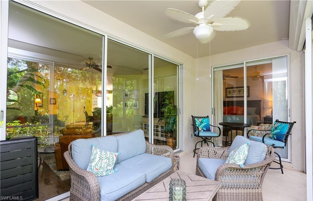 3775 Fieldstone Boulevard, Unit 102 Naples, FL 34109 - Photo 3 of 27 a living room with furniture and a large window