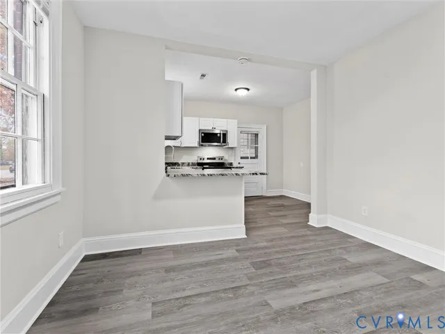 a view of kitchen and wooden floor