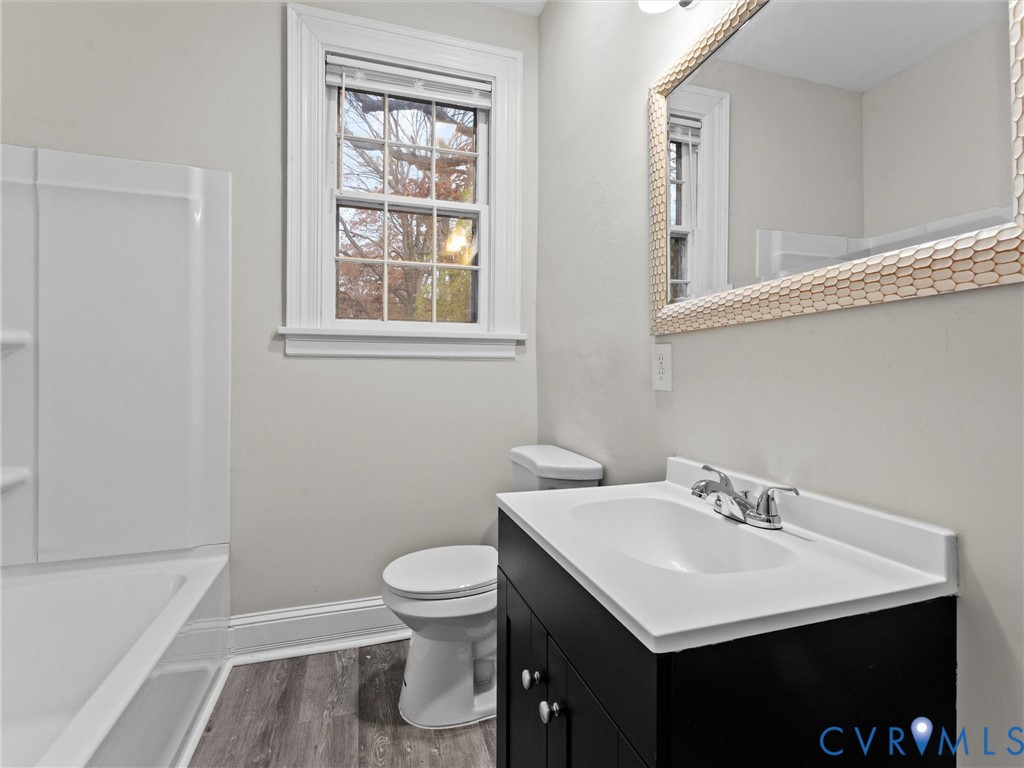 3928 East Broad Rock Road Richmond, VA 23224 - Photo 14 of 34 a bathroom with a sink toilet and a bathtub
