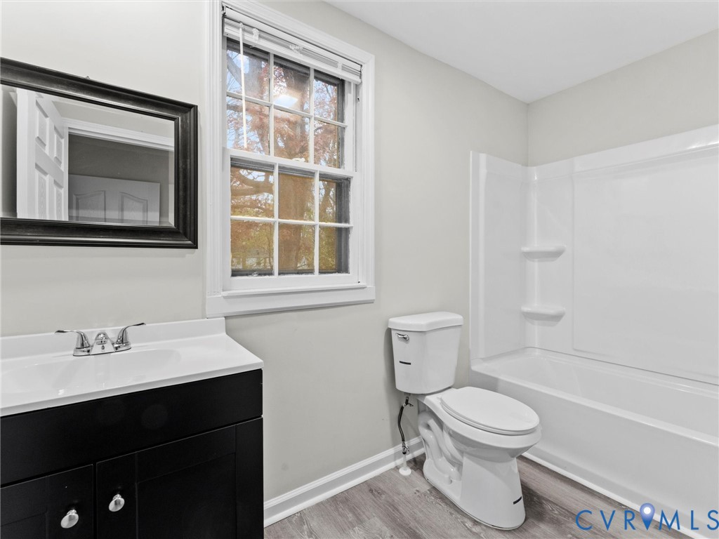 3928 East Broad Rock Road Richmond, VA 23224 - Photo 20 of 34 a bathroom with a toilet sink a mirror and shower