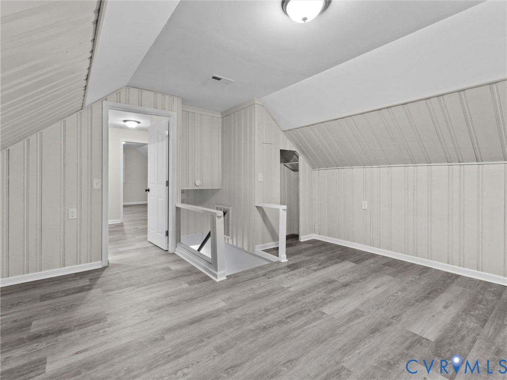 3928 East Broad Rock Road Richmond, VA 23224 - Photo 24 of 34 an empty room with wooden floor and mirror