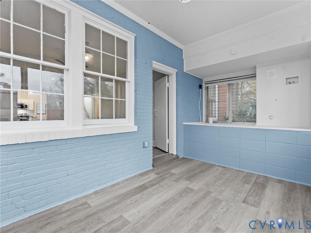 3928 East Broad Rock Road Richmond, VA 23224 - Photo 30 of 34 a view of an empty room with wooden floor and windows