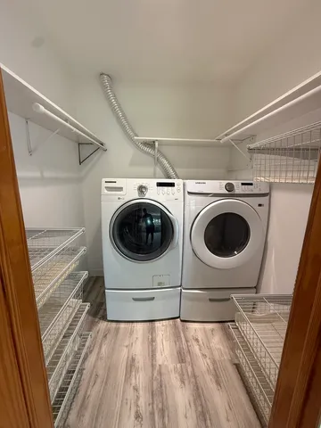 a view of hallway with wooden floor and stairs