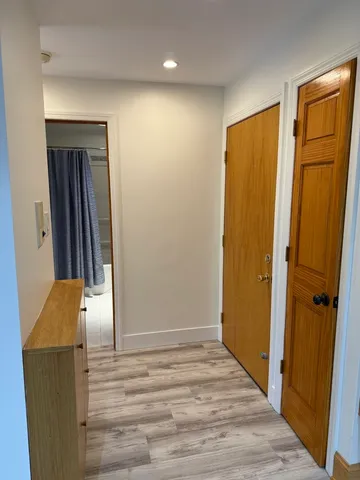 a view of hallway with wooden floor