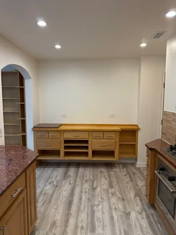 a view of room with cabinets and wooden floor
