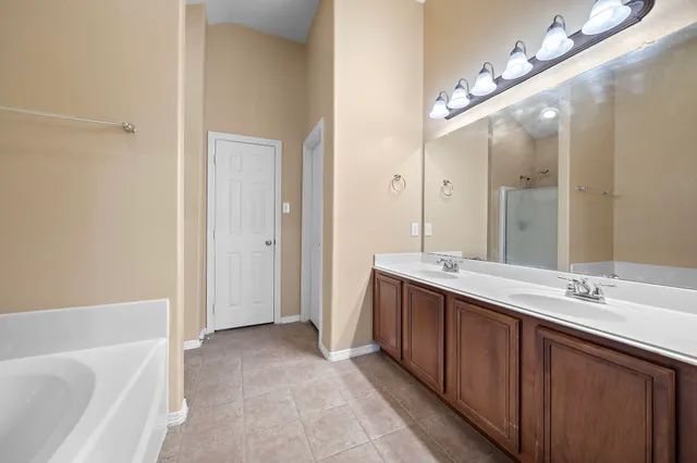 a bathroom with a double vanity sink mirror and double