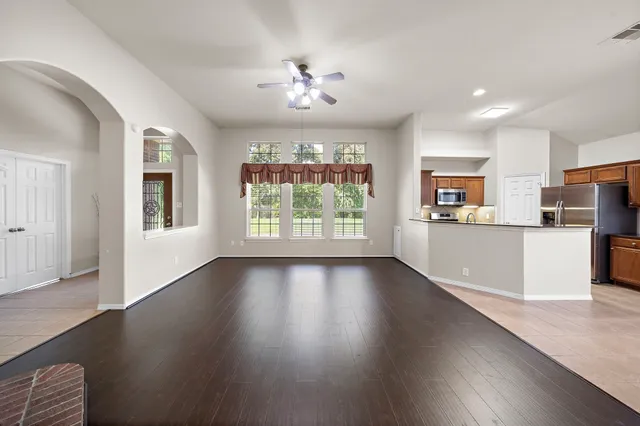 a view of a kitchen with furniture wooden floor and windows