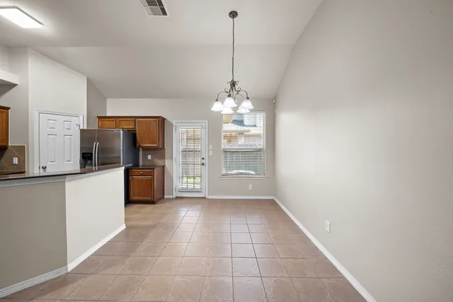 a view of a kitchen with a sink and refrigerator