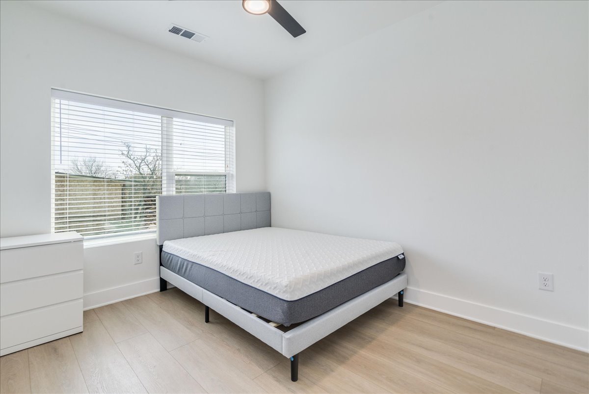 3000 Duval Street, Unit 203 Austin, TX 78705 - Photo 13 of 27 a bed sitting in a room next to a window