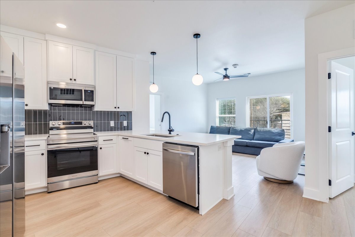 3000 Duval Street, Unit 203 Austin, TX 78705 - Photo 27 of 27 a kitchen with stainless steel appliances granite countertop a stove and a sink