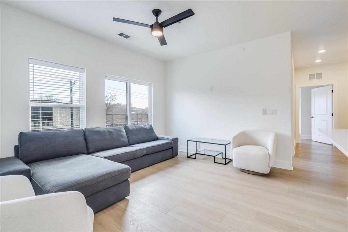 a living room with furniture and a large window