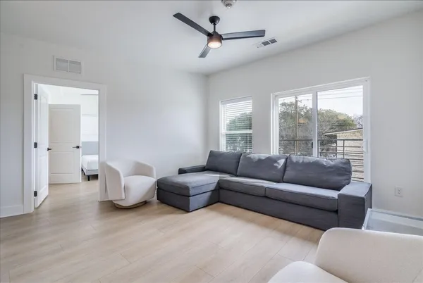 a kitchen with stainless steel appliances granite countertop a stove a refrigerator a sink a microwave a counter top and oven with wooden floor
