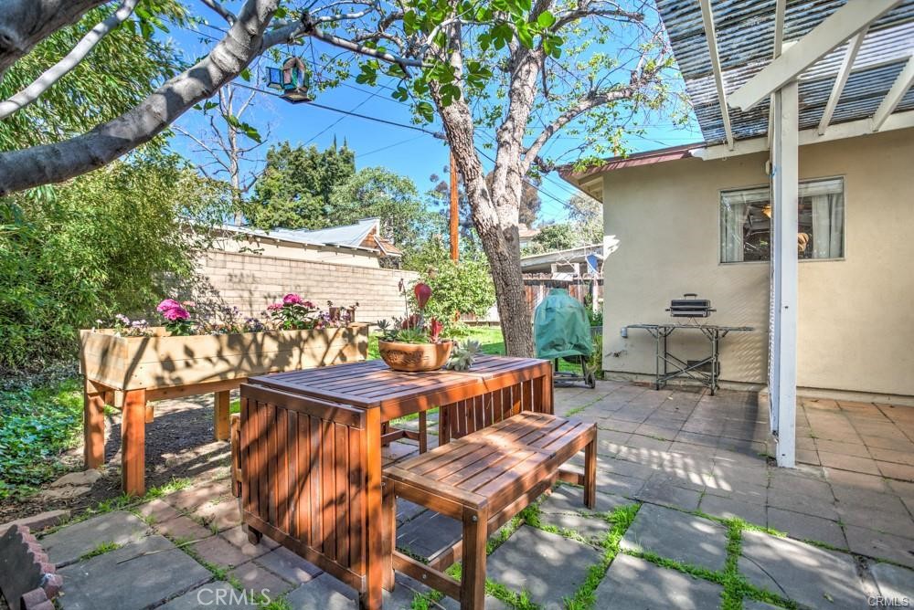 a view of a patio with table and chairs and potted plants
