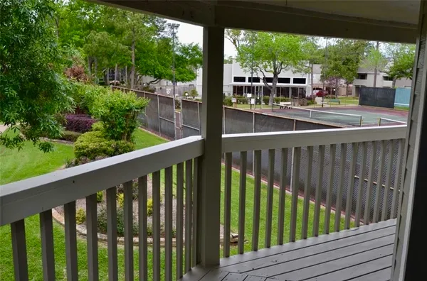 a view of a balcony with wooden floor