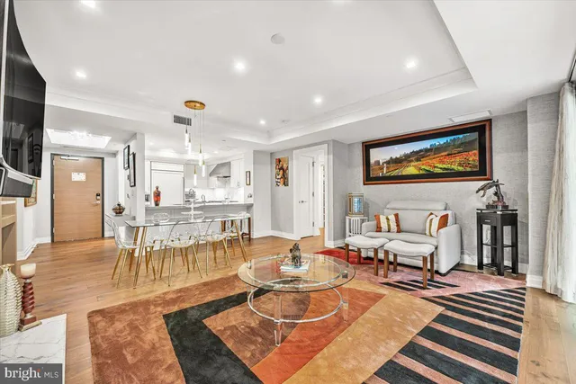a living room with furniture a rug and a flat screen tv