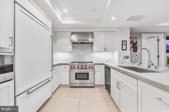 a kitchen with a sink and a stove top oven