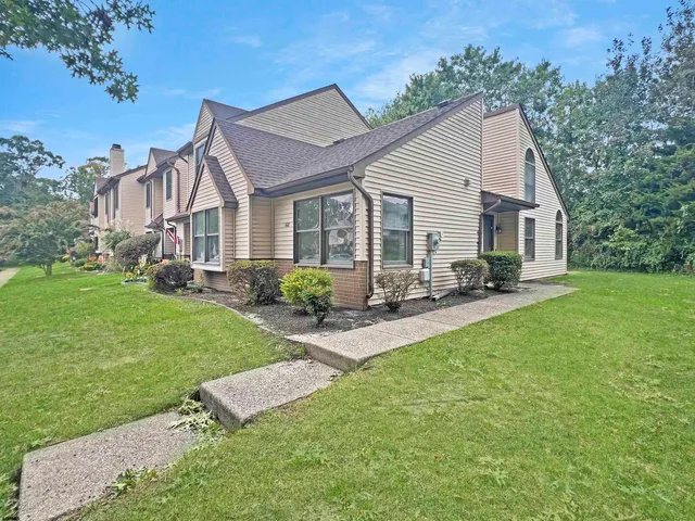 a front view of house with yard and outdoor seating