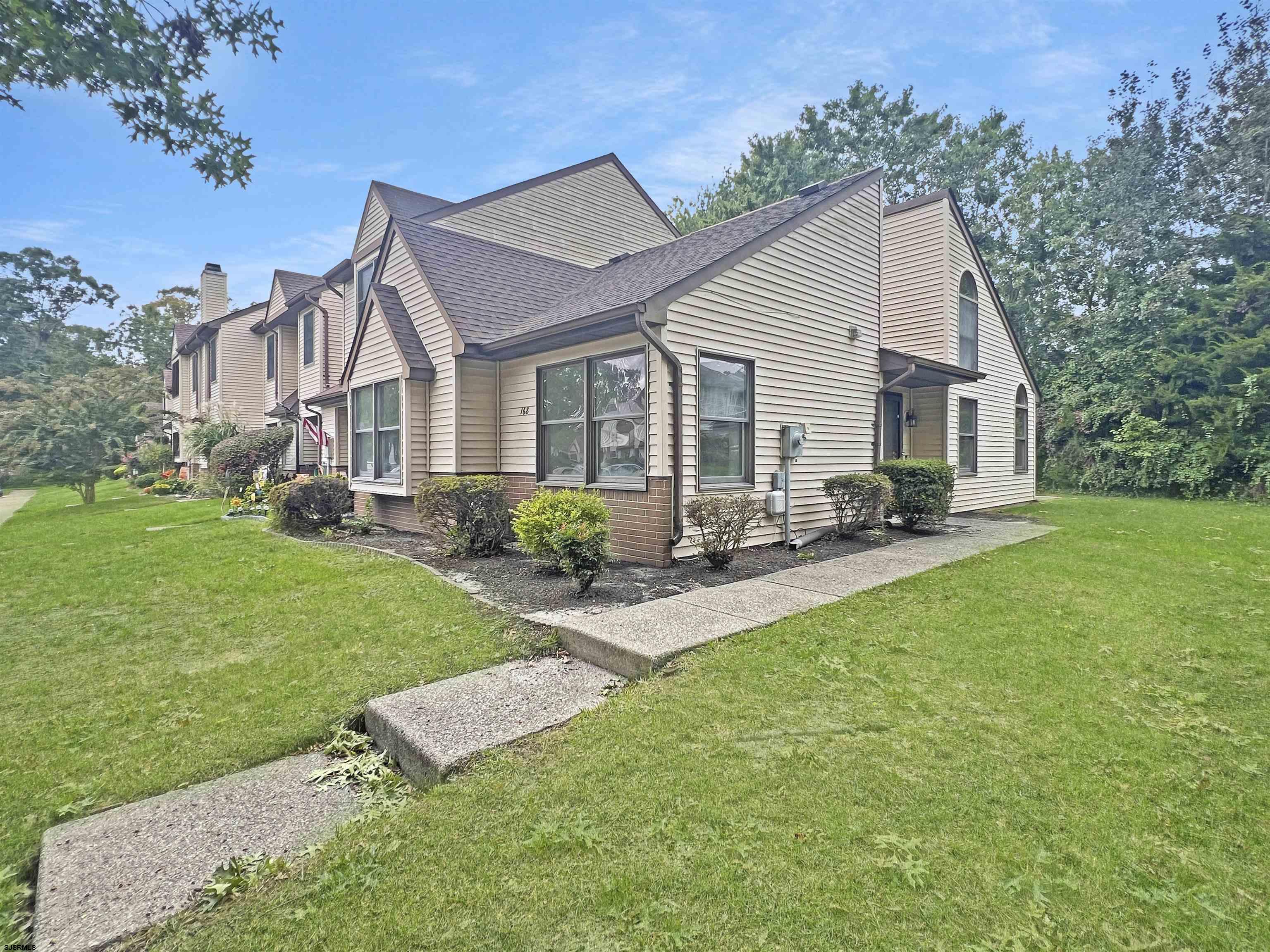 168 Westchester Drive, Unit 168 Little Egg Harbor, NJ 08087 - Photo 1 of 21 a front view of house with yard and outdoor seating
