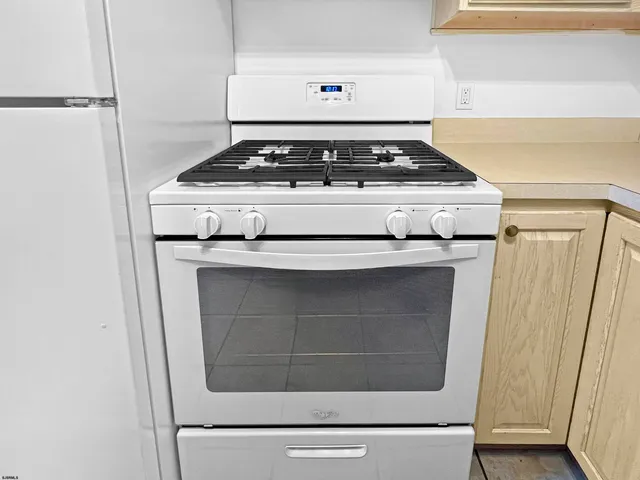 a white refrigerator freezer and a stove sitting inside of a kitchen