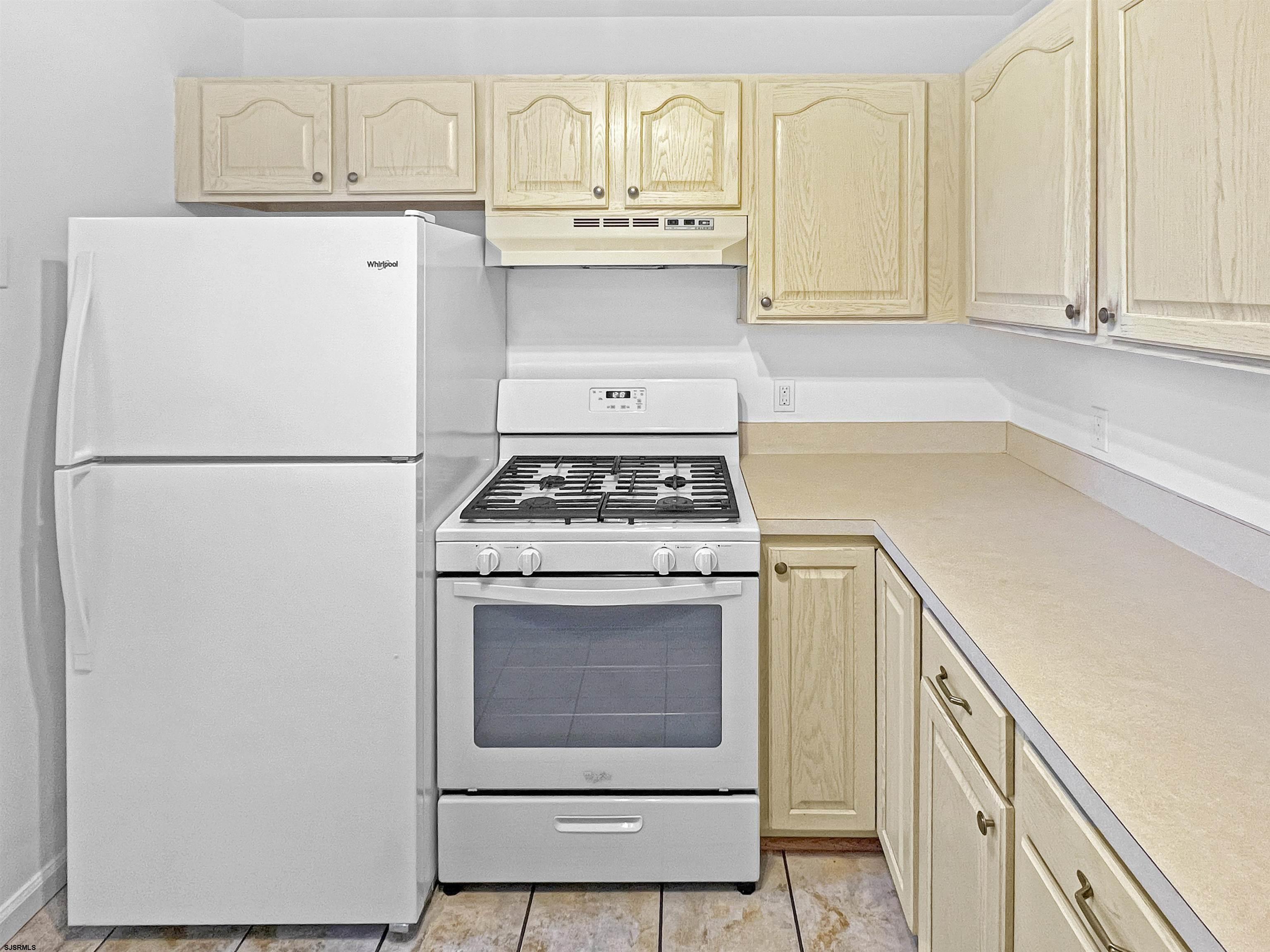 168 Westchester Drive, Unit 168 Little Egg Harbor, NJ 08087 - Photo 13 of 21 a white refrigerator freezer and a stove sitting inside of a kitchen