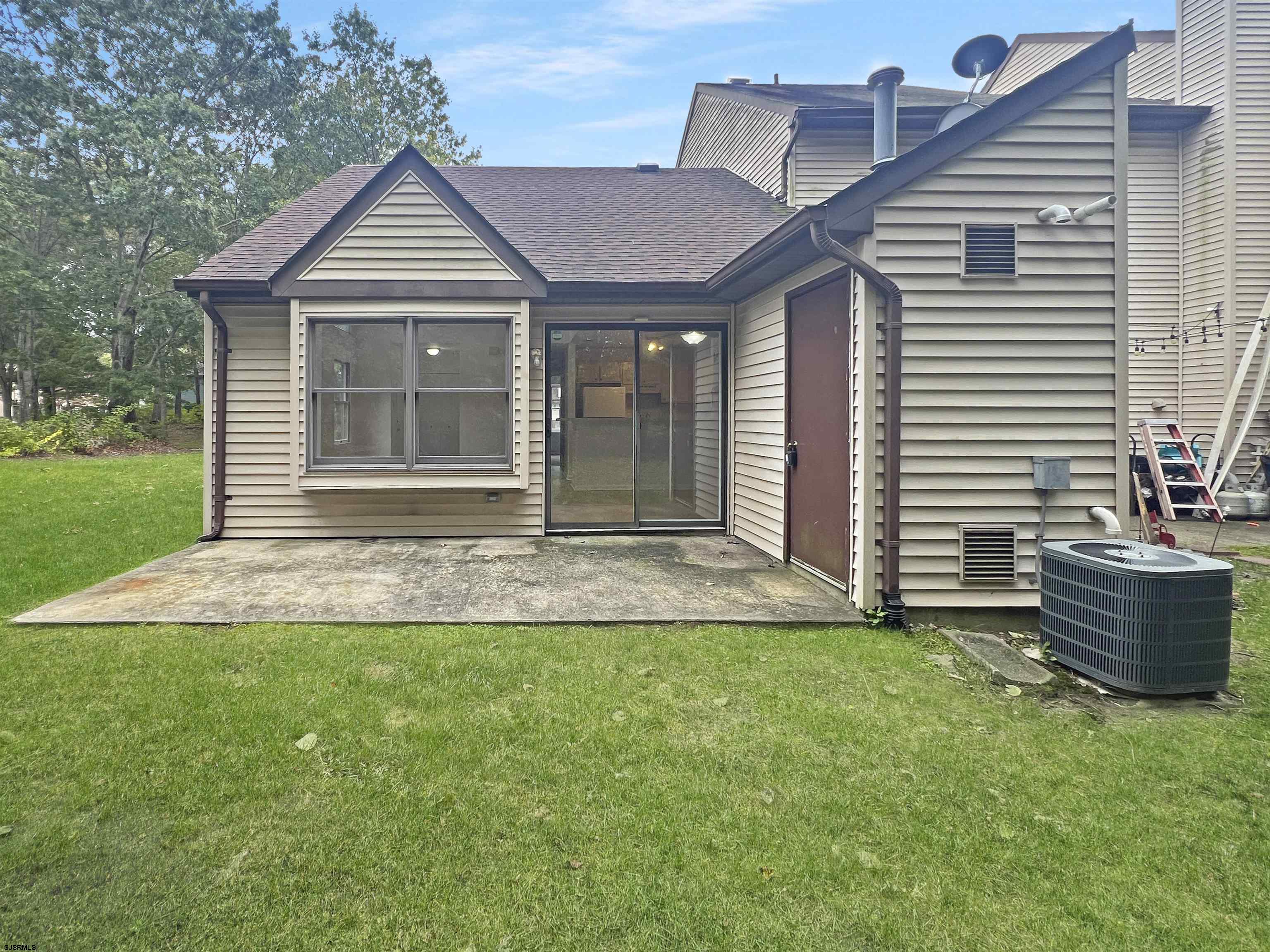 168 Westchester Drive, Unit 168 Little Egg Harbor, NJ 08087 - Photo 2 of 21 a front view of a house with a yard
