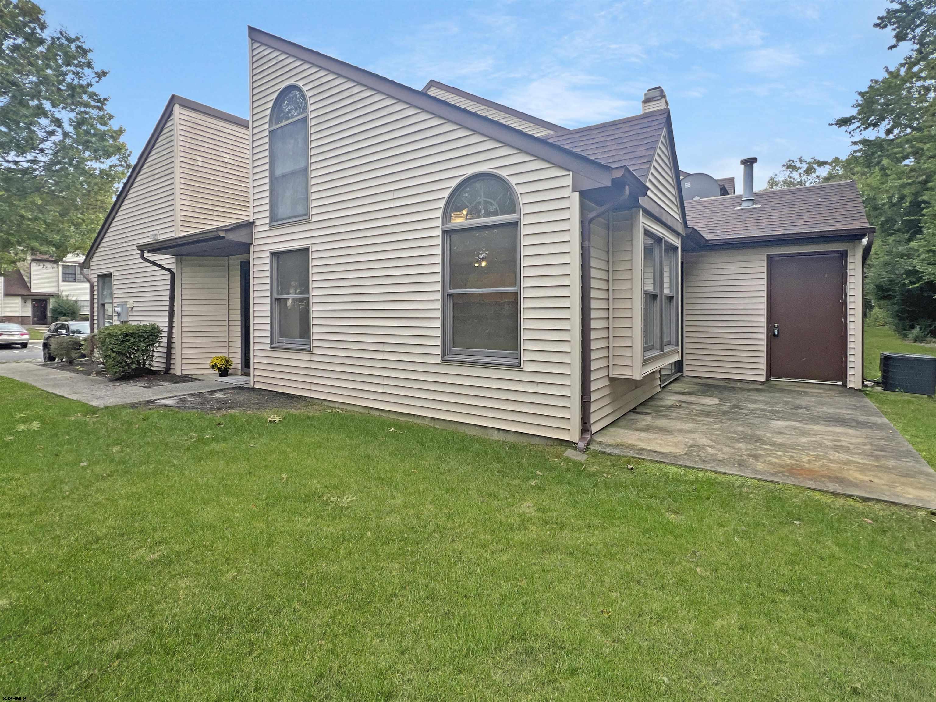 168 Westchester Drive, Unit 168 Little Egg Harbor, NJ 08087 - Photo 3 of 21 a front view of a house with a yard