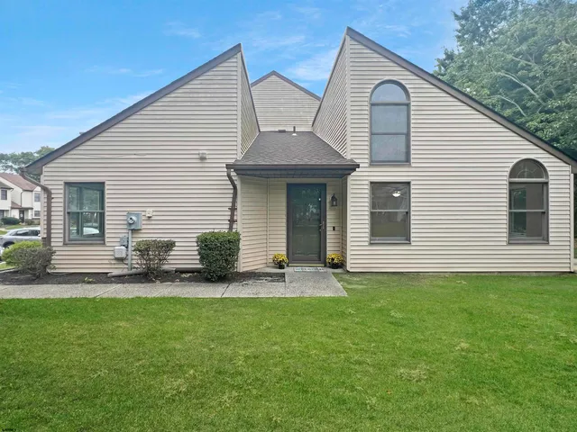 a view of a house with a backyard