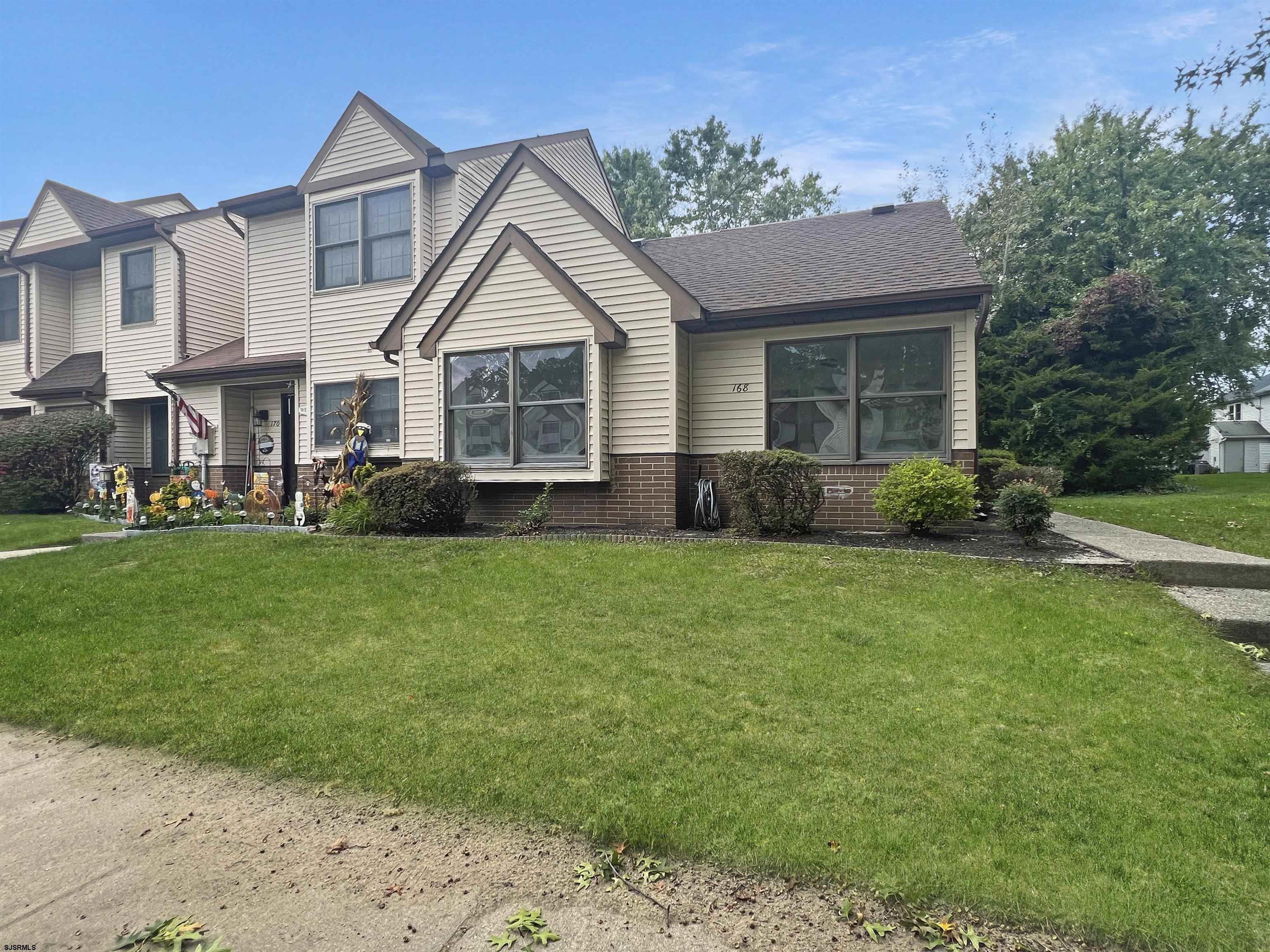 168 Westchester Drive, Unit 168 Little Egg Harbor, NJ 08087 - Photo 5 of 21 a view of a house with a yard and potted plants