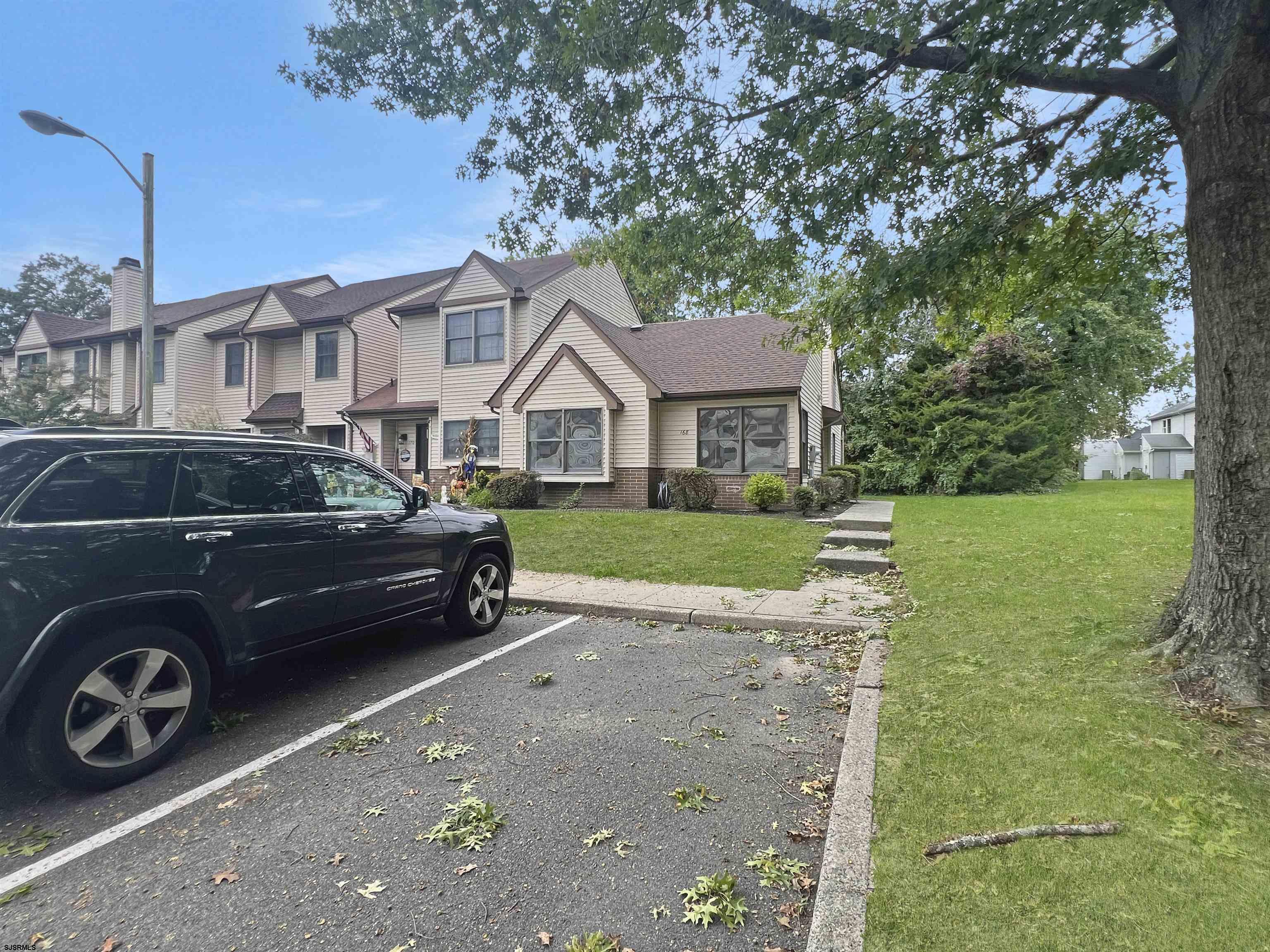 168 Westchester Drive, Unit 168 Little Egg Harbor, NJ 08087 - Photo 6 of 21 a front view of a house with a garden