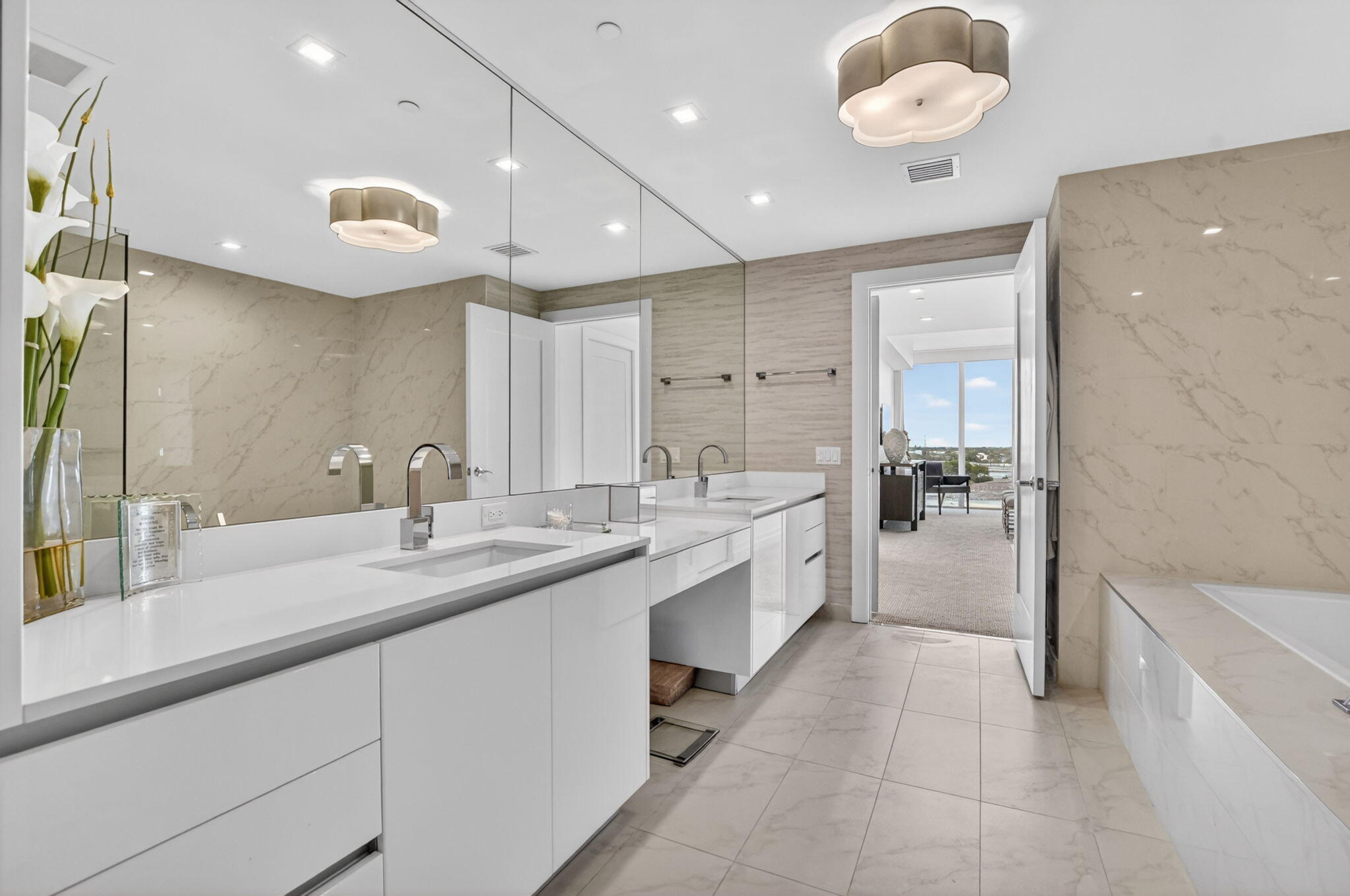 20155 Boca W Drive, Unit B701 Boca Raton, FL 33434 - Photo 22 of 78 a large white kitchen with a large island a sink stainless steel appliances and cabinets