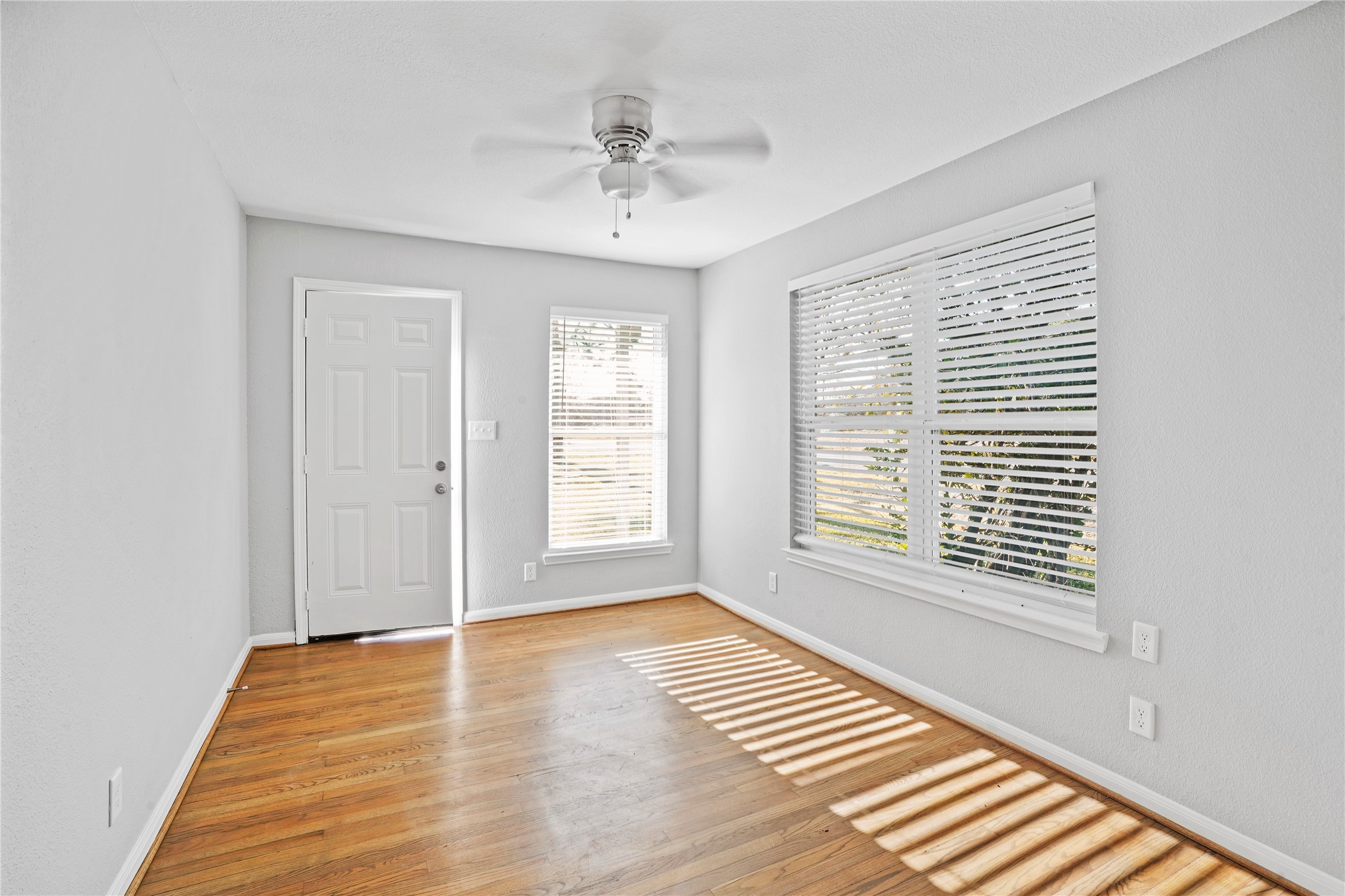 819 Oak Street, Unit 3 La Marque, TX 77568 - Photo 4 of 9 a view of an empty room with wooden floor and a window