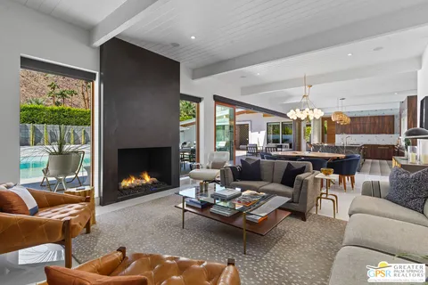 a front view of a house with a yard and garden