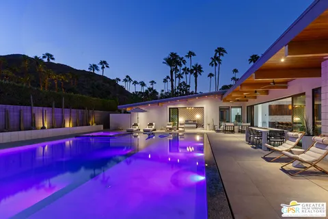 a living room with furniture fireplace and a large window