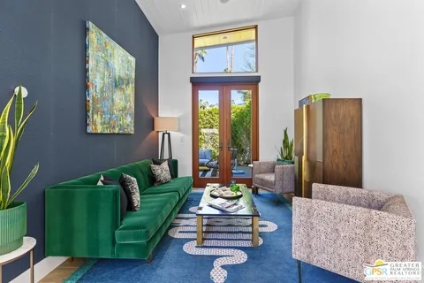 a view of a patio with couches table and chairs and potted plants