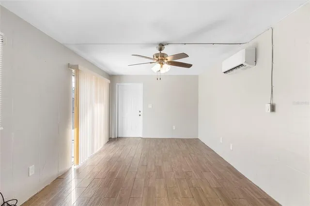 wooden floor in an empty room with a window
