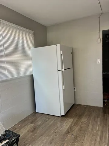 a view of a room with wooden floor