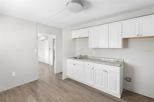 a kitchen with granite countertop a sink and cabinets