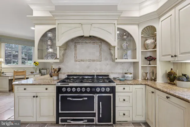 a living room with fireplace furniture and a large window