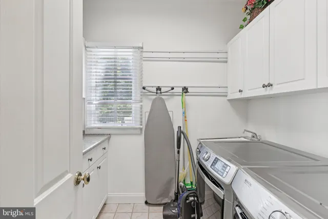 a room with pool table and windows