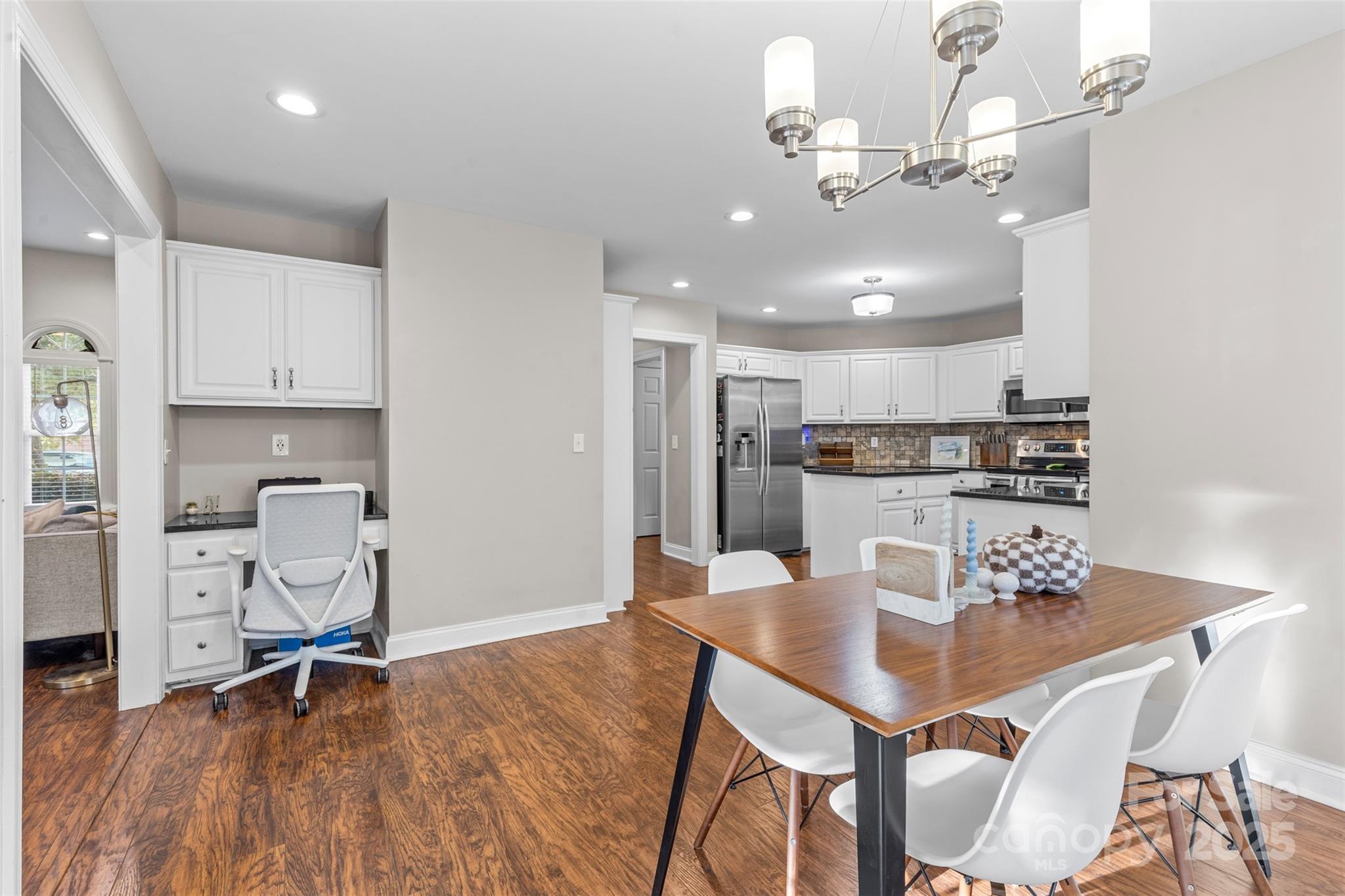 1108 Blowing Rock Cove Fort Mill, SC 29708 - Photo 10 of 43 a view of a dining room with furniture and wooden floor
