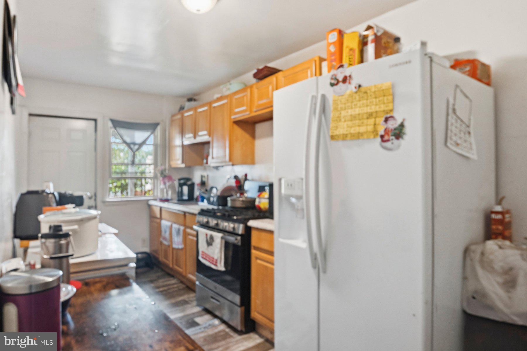 4931 Brookwood Road Baltimore, MD 21225 - Photo 9 of 25 a kitchen with stainless steel appliances granite countertop a refrigerator and a stove