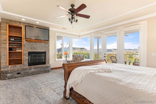 a bedroom with a bed wooden floor and a window